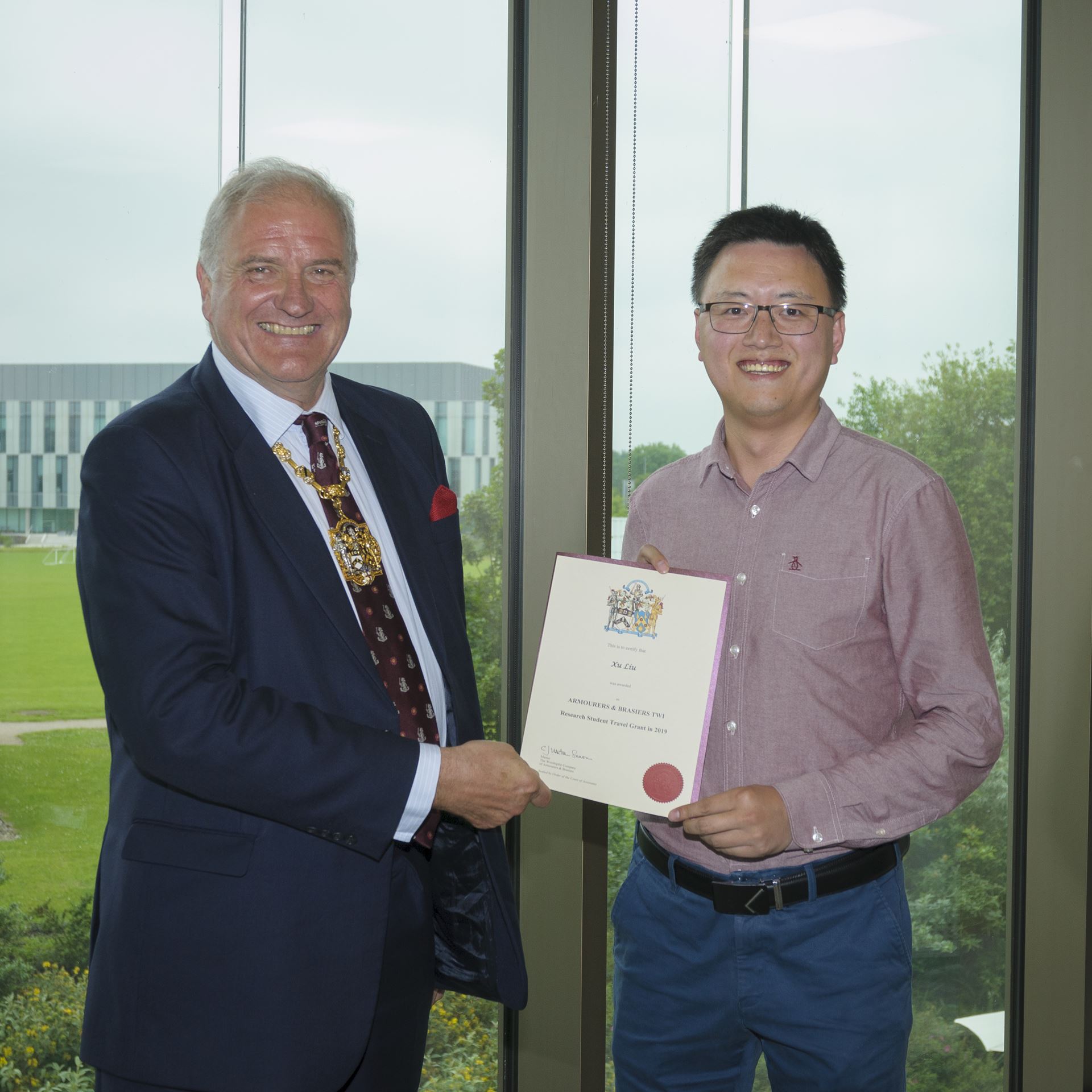 Xu Liu (pictured right) receiving the 2019 Armourers and Brasiers Travel Award 